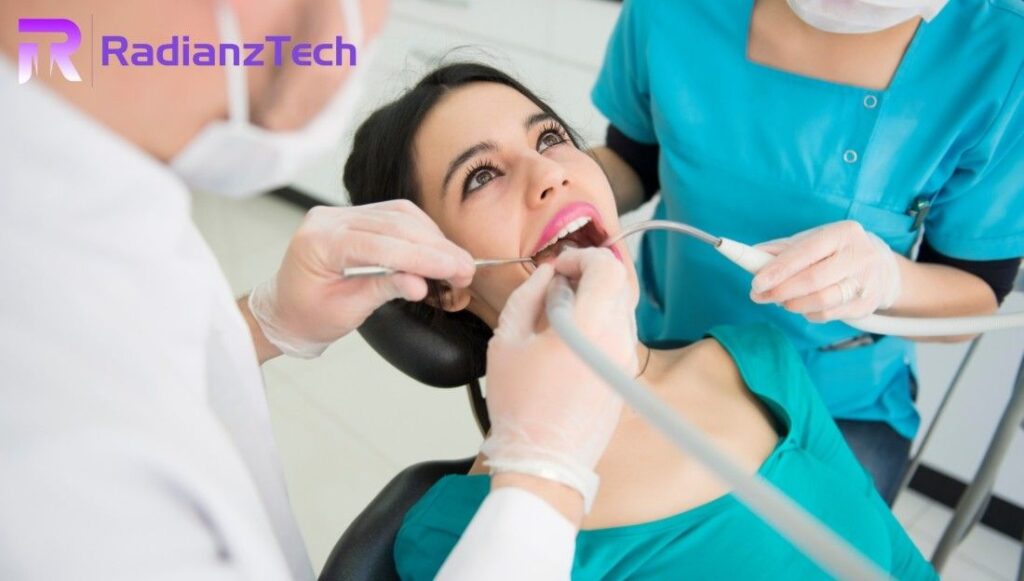 A patient receiving dental treatment from a dentist and assistant in a clinic, illustrating healthcare procedures — Radianz Tech Dental Billing Services.