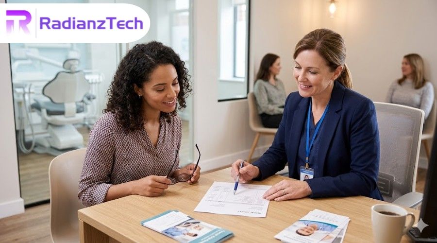 Woman explaining dental billing terms to patient in clinic office with documents and guidance
